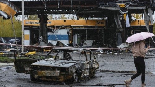 A woman passes by a gas station destroyed by yesterday's Russian military strike, as Russia's attack ... A woman passes by a gas station destroyed by yesterday's Russian military strike, as Russia's attack ...