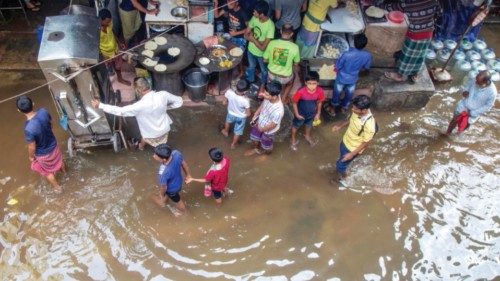 epa10264492 Bangladeshi people walk through a flooded area after the passing of Cyclone Sitrang, ... epa10264492 Bangladeshi people walk through a flooded area after the passing of Cyclone Sitrang, ...