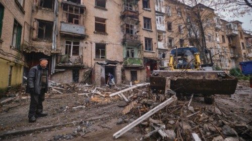 epa10267255 Communal workers clean debris of a residential building damaged in an overnight shelling ...