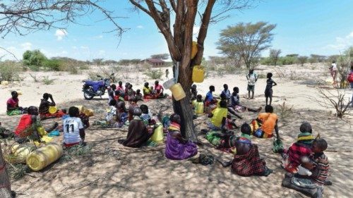 Women from the pastoral Turkana community wait on October 18, 2022 with their children under a tree ...