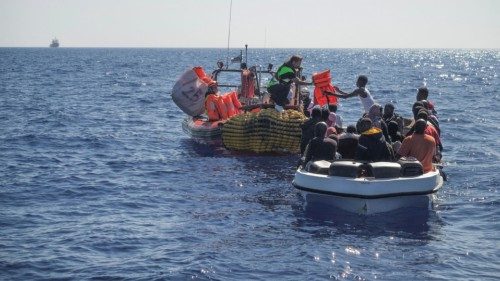 Crew members of NGO rescue ship 'Ocean Viking' give lifejackets to migrants on an overcrowded boat ... Crew members of NGO rescue ship 'Ocean Viking' give lifejackets to migrants on an overcrowded boat ...
