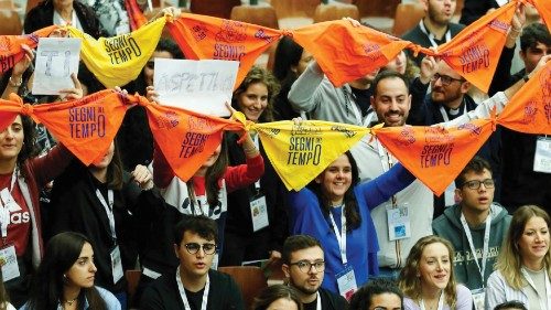 People hold banners that reads 'the signs of the time', as Pope Francis meets young people of the ... People hold banners that reads 'the signs of the time', as Pope Francis meets young people of the ...