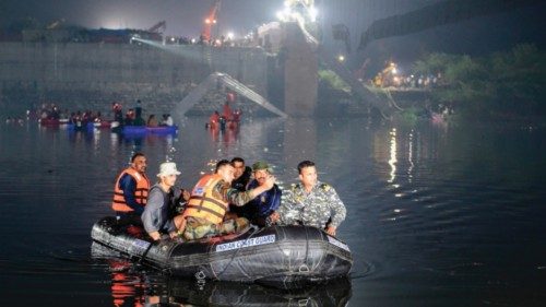 TOPSHOT - Indian rescue personnel conduct search operations after a bridge across the river Machchhu ...