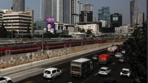 An election billboard depicting Israeli Transportation Minister Merav Michaeli overlooks a railway ...