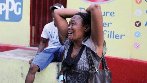 A woman reacts during a protest to demand the release of journalist Robest Dimanche near a police ...
