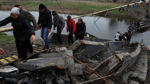 People leave and return to their shelters as they cross a destroyed bridge in order to collect aid, ...