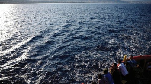 FILE PHOTO: Migrants are on deck before arriving at the port of Messina on board of Open Arms Uno ...