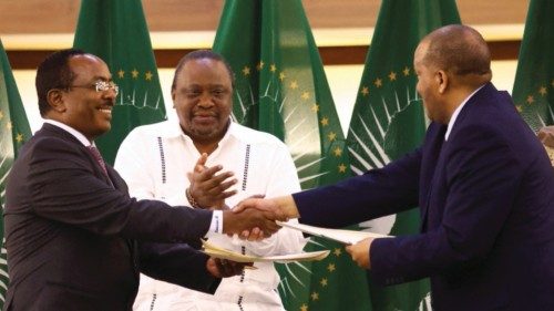 Former Kenyan President Uhuru Kenyatta applauds Ethiopian government representative Redwan Hussien ...