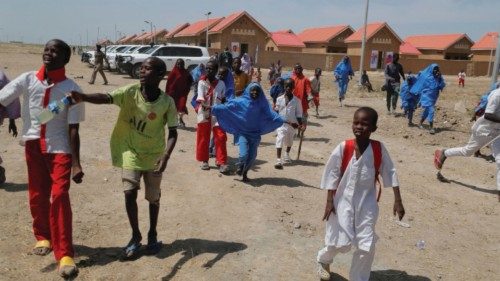 FILE PHOTO: Displaced children run to attend the community reopening ceremony which was destroyed by ...