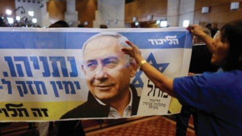 A person holds a banner in support of Likud party leader Benjamin Netanyahu, following the ... A person holds a banner in support of Likud party leader Benjamin Netanyahu, following the ...