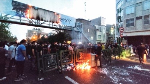 FILE PHOTO: People light a fire during a protest over the death of Mahsa Amini, a woman who died ...