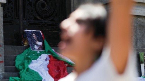 A view shows a picture of Mahsa Amini is placed on the street with an Iranian flag, while the ...