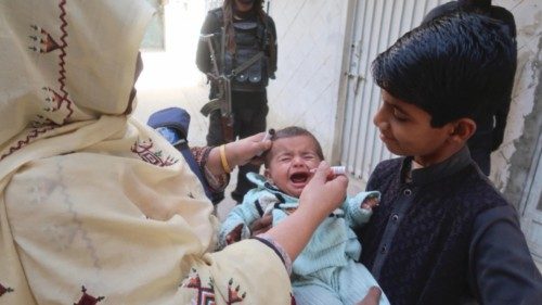 epa10266891 A health worker administers polio drops to a child during a polio vaccination campaign ...