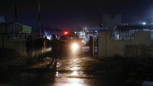Iraqi security forces stand guard outside the hospital where the body of a U.S. citizen who was ...