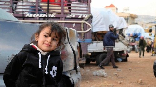 epa10266571 A Syrian refugee looks on as she waits to leave the Arsal area back to Syria, at Arsal ...