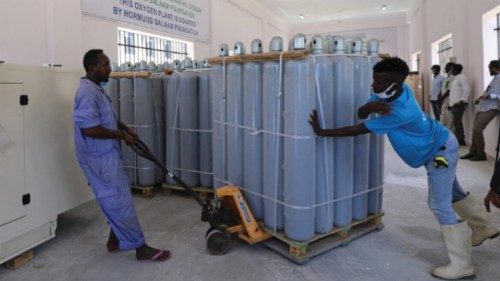 Workers arrange empty medical oxygen cylinder tanks at the public oxygen plant, amid the coronavirus ...