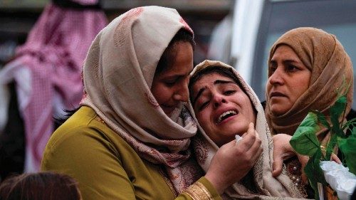 Relatives mourn as they wait for the bodies of nine Kurdish migrants, who died last month after ...