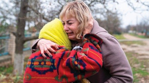 50-year school head Svitlana Striletska (R) reacts with 84-year Galina Timofievna (L), as they hug ...