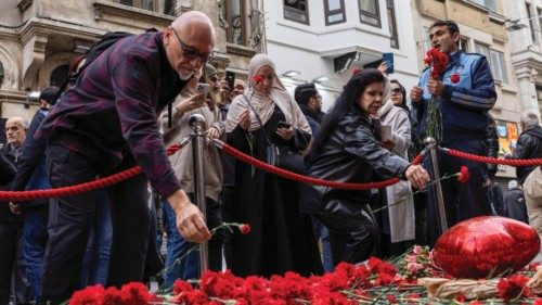 People lay flowers to pay tribute to the victims of a Sunday's blast that took place on Istiklal ...