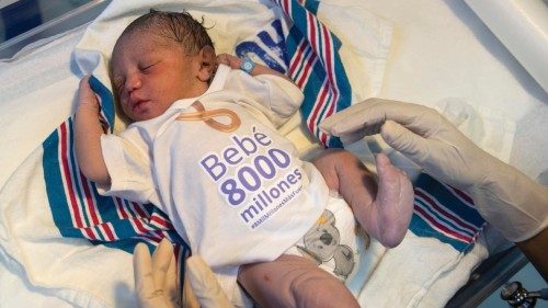 epa10306422 A nurse puts a T-shirt reading '8 Billion Baby' on newborn Damian, at the Altagracia ...