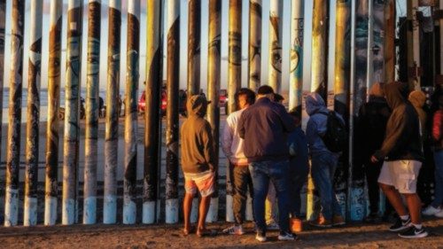 epa10305522 A group of people observe the rescue of the body of a migrant of Russian origin, in the ...