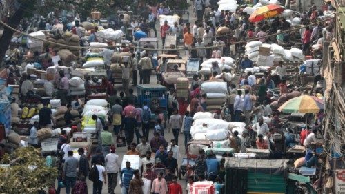 epa10306932 People walk through a congested road of a wholesale market in the old quarters of Delhi, ...