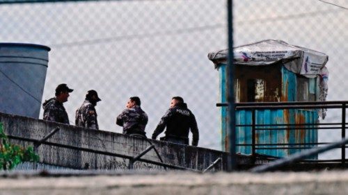 Police officers stand guard on a roof of the Pichincha 1 prison in Quito on November 8, 2022, a day ...