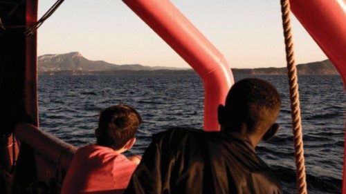 Migrants stand on board the Ocean Viking prior disembarking in Toulon on November 11, 2022, after ...