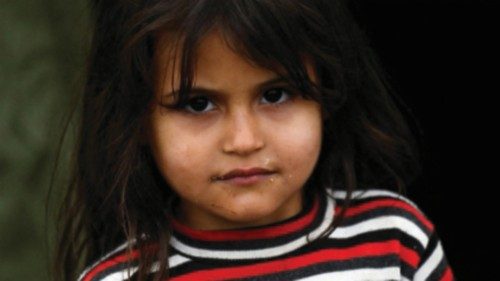 A child looks on at a tent camp for migrants in Kuty, near the Czech-Slovak border, Slovakia, ...