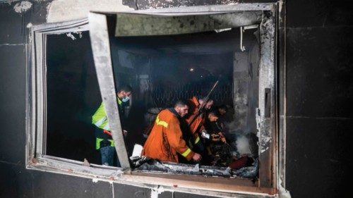 Palestinian firefighters extinguish flames in an apartment ravaged by fire in the Jabalia refugee ...