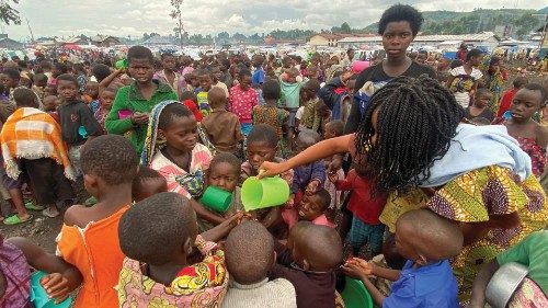 Internally displaced children wash their hands as they wait to receive porridge from volunteers at ... Internally displaced children wash their hands as they wait to receive porridge from volunteers at ...