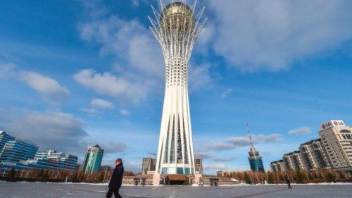 A man walks past the Baiterek observation tower in central Astana on November 18, 2022, ahead of ...