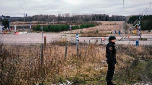 A border guard officer stands near the pillars marking the boundary between the Russian Federation ...