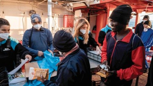 Migrants prepare to disembark from the Ocean Viking on November 11, 2022, after being rescued by ...