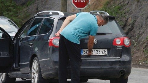 FILE PHOTO: A driver removes a sticker covering the national markings on his car plates at the ... FILE PHOTO: A driver removes a sticker covering the national markings on his car plates at the ...