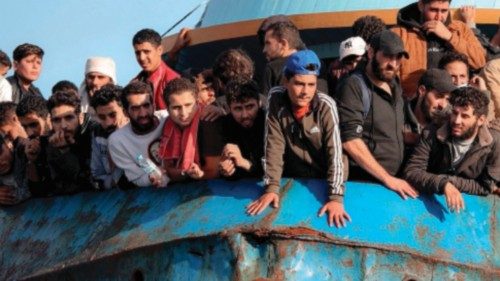 TOPSHOT - Rescued refugees and migrants stand aboard a boat at the town of Paleochora, southwestern ...