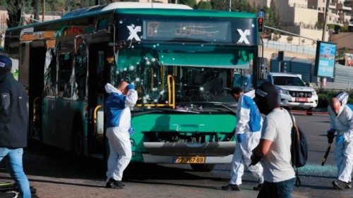 Israeli forensic experts collect evidence at the scene of an explosion at a bus stop in Jerusalem on ...