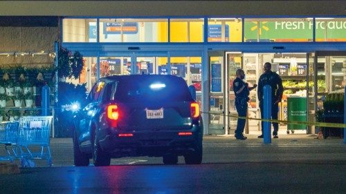 epa10322274 Police officers work at the scene of a mass shooting at the Walmart Supercenter in ...