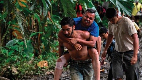 Venezuelan migrant Jesus Arias is helped by a friend as they arrive at Canaan Membrillo village, the ... Venezuelan migrant Jesus Arias is helped by a friend as they arrive at Canaan Membrillo village, the ...