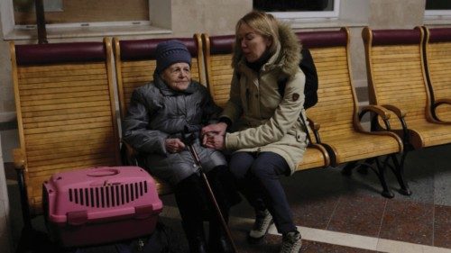 People wait to board a train bound for Kyiv, after Russia's military retreat from Kherson, at the ...