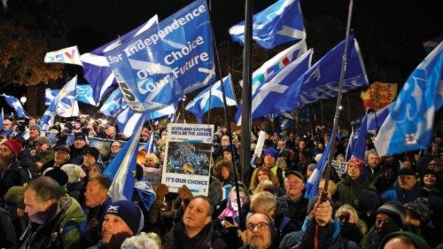 TOPSHOT - Pro-Scottish independence supporters wave Saltire flags during a rally outside parliament ...