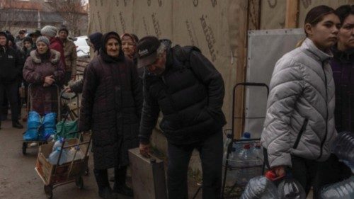 epa10325930 People wait in line to fill up bottles with drinking water from a well, in Kherson, ...