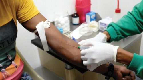FILE PHOTO: A nurse draws a blood sample for an HIV test at the lab of the NGO 'Accion Solidaria' ...