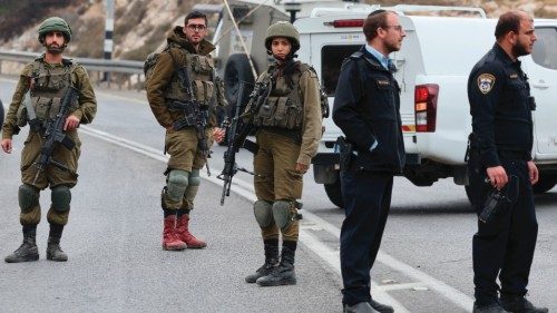 EDITORS NOTE: Graphic content / Israeli army soldiers and police gather at the scene of a ramming ...