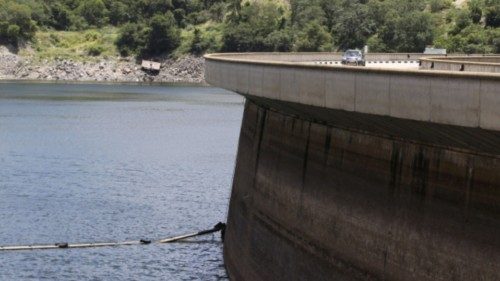 FILE PHOTO: A motorist drives on top of the Kariba Dam wall in Kariba, Zimbabwe, February 19, 2016. ...