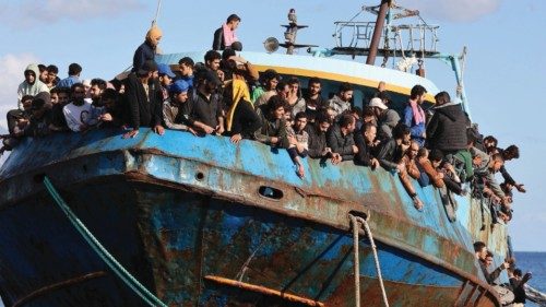 Migrants sit onboard a fishing boat at the port of Paleochora, following a rescue operation off the ...