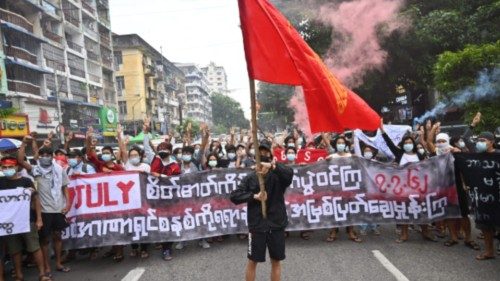 (FILES) In this file photo taken on July 07, 2021, protesters hold a banner that reads 'Fight by ...