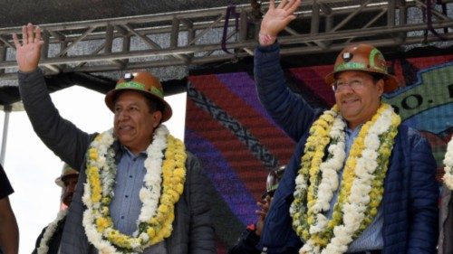Bolivia's Vice President David Choquehuanca and President Luis Arce wave to the crowd at a miners ...