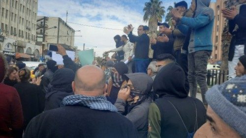 People gather as they take part in a protest in Sweida, Syria, December 4, 2022, in this picture ...
