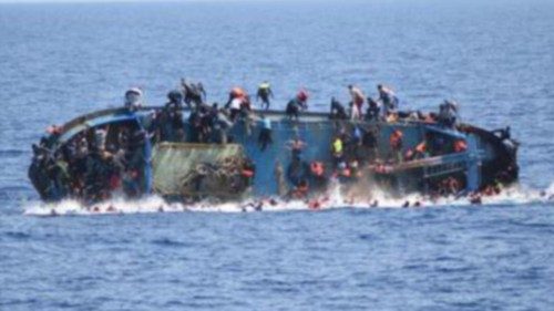 A handout picture released by the Italian Navy shows people jumping out of a boat right before it ...